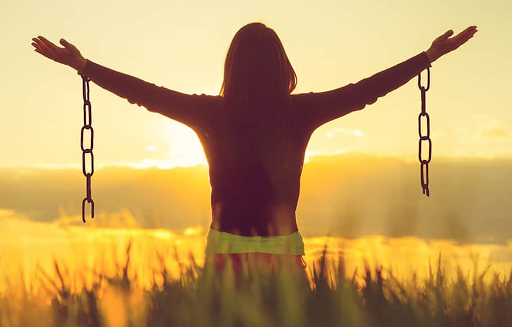 Picture of man wearing chains that have been cut, setting him free